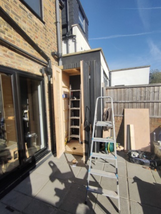 Shed with charred wood clading 2 doors open